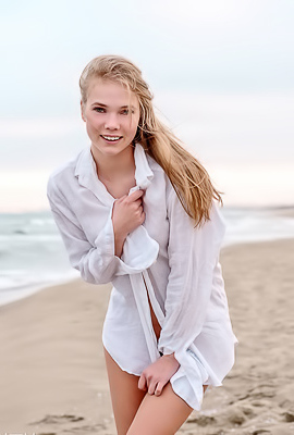 Luise Entices With A Beach Striptease Revealing Perky Nipples And Grabbing Her Curves