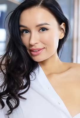 Milena Ray Teases With A Sultry Glance On Blue Chair