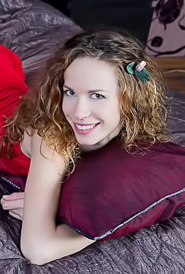 Dennie Playfully Smiles in Red Lingerie, Captivated By the Bedroom Gaze